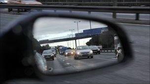 Car with cars shown in wing mirror