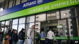 Unemployed people queue outside an unemployment registry office in Portugal