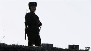 North Korean soldier on watch on the banks for the Yalu River, across the border from China on 26 November 2010