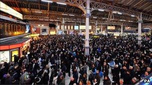 Passengers at Victoria Station in London as bad weather causes delays to train services