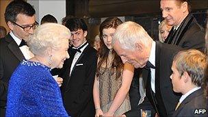 The Queen meets director Michael Apted (bowing) as Liam Neeson (r) looks on