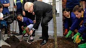 London Mayor Boris Johnson along with pupils from Kings Avenue Primary School helps to plant a tree in Brixton