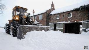 Snow being removed from a rural house outside York