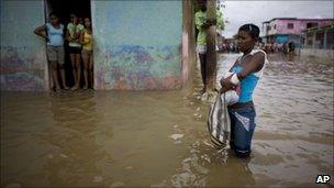 A young woman stands in a flooded street in Higuerote, Venezuela