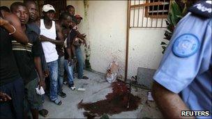UN policeman near blood stains at RDR office