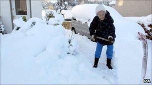 Woman clearing snow in Kippen