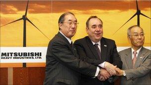 Scotland"s First Minister Alex Salmond (C), the chief executive of Mitsubishi Power Systems Europe, Akio Fukui (L), and the vice president of Mitsubishi Heavy Industries, Atsushi Maekawa, pose for photographers