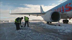 Workers clearing snow from the runway at Robin Hood Airport