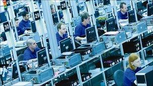 Workers in a factory making cameras