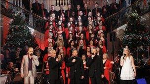 Carol singers and the Priests singing on the steps inside Stormont's Great Hall