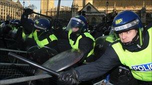 Police hold back student protesters outside the Houses of Parliament