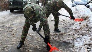 Soldiers clearing snow