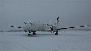 Plane covered in snow at Guernsey Airport