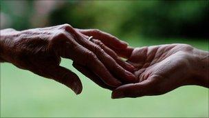 Hands of elderly and young woman