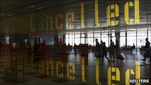 Flight cancellations reflected in a window