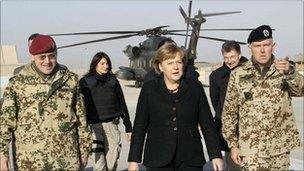 German Chancellor Angela Merkel (centre) arrives for a visit at an army camp in Kunduz, northern Afghanistan, on Saturday