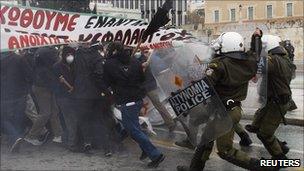 Riot policemen chase away protesters during clashes in central Athens