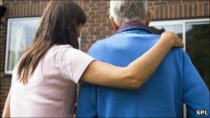 Woman helping elderly man