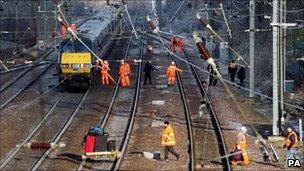 Passengers are led off a train outside Huntingdon Railway station in Cambridgeshire