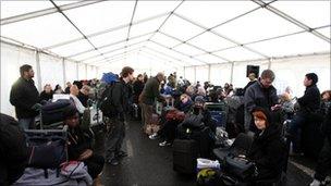 Passengers waiting in a marquee outside Heathrow Terminal 3