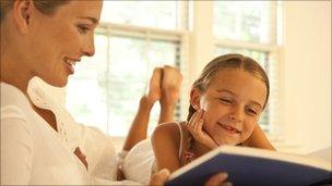 Adult and child reading together [Thinkstock]