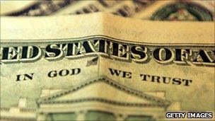 A ten dollar bill with the phrase "In God We Trust"