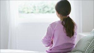 A girl sitting on a bed