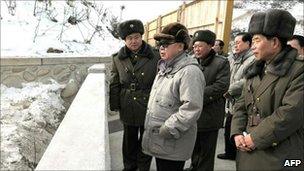North Korean leader Kim Jong-il in newly released pictures of an undated visit to the Huichon youth electrical complex in Chagang Province