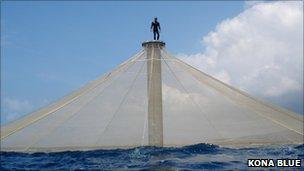 Man on top of pillar at fish farm