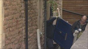 Police remove the front door of Ms Yeates' flat