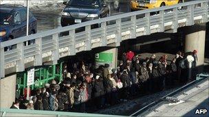 Passengers line up for taxis at La Guardia airport