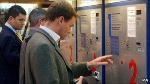 Passengers using a rail ticket machine