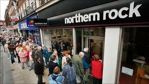 Customers wait in line to remove their savings from a branch of The Northern Rock bank on September 17, 2007 in Kingston-Upon-Thames, England.