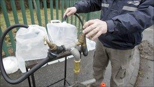 Man filling up bottles of water