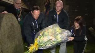 Mark Taylor and John Hartson place flowers on Guto Nyth Bran's grave