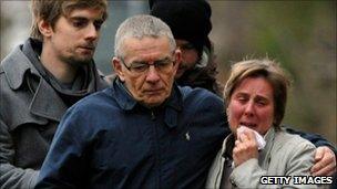 Theresa Yeates (right) is hugged by Jo's father David Yeates, with Jo's brother Chris (left)