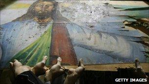 Egyptian Christians hold a blood-stained portrait of Jesus - January 2