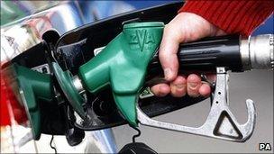 Motorist filling his car with petrol