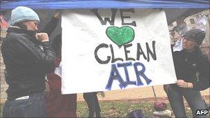 Protesters holding up a banner saying We Love Clean Air