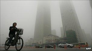 A cyclist in Beijing smog