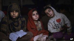 Child refugees learn how to read the Koran at a mosque in an Islamabad slum