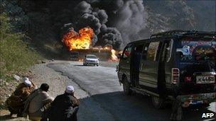 Pakistani onlookers watch a burning Nato oil tanker in Khyber tribal district