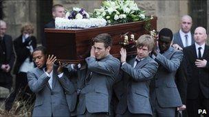 Dale Roberts' coffin is carried from the church