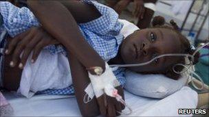 A young girl with cholera lies on a bed at St Nicholas Hospital in St Marc, 25 October 2010.