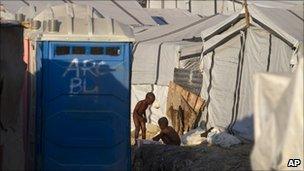 Children bathe by their tents at a camp for people displaced by the earthquake in Port-au-Prince, Haiti, 2 December 2010.