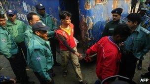 Handcuffed Bangladesh Rifles (BDR) soldiers arrive at the special court in Dhaka on January 5, 2011.