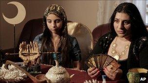 Romanian witch Mihaela Minca (R) talks to the Associated Press alongside her daughter and apprentice Casanndra in Mogosoaia, 5 January