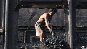 Man shovelling coal