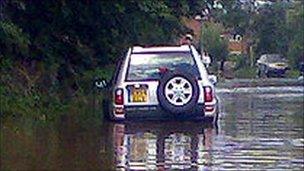 Car on flooded road - generic