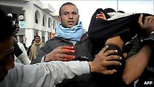 An injured demonstrator is carried away by fellow protesters in the town of Regueb